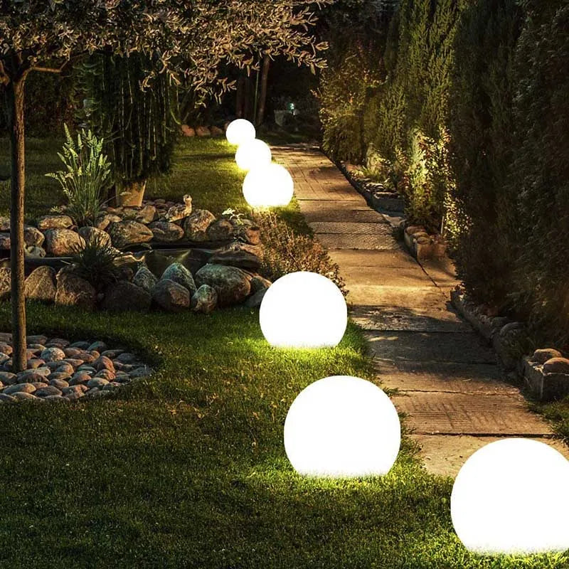 Waterproof RGB Color-Changing LED Ball Lights illuminating a garden path at night.